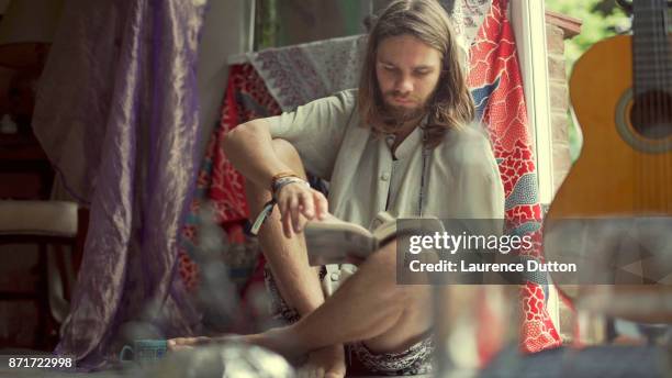 hippie reading book - hippies 1960s stock pictures, royalty-free photos & images