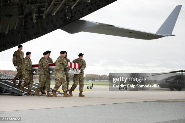 Army cary team carries the flag-draped transfer case containing the remains of Sgt. 1st Class Stephen B. Cribben during his dignified transfer at...