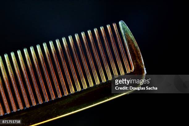 close-up of a grooming comb on a black background - pettine foto e immagini stock