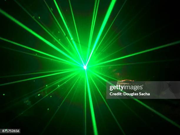 green colored laser light in a dark room - laser weapon stock pictures, royalty-free photos & images