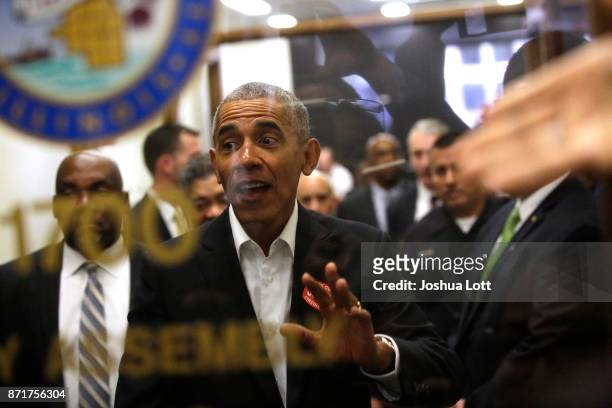 Former President Barack Obama waves to a crowd of people as he attends Cook County jury duty at the Daley Center on November 8, 2017 in Chicago,...