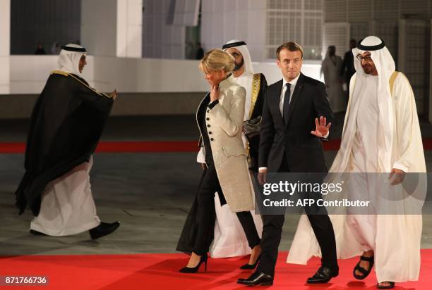 Ruler of Dubai Sheikh Mohammed bin Rashid al-Maktoum and Abu Dhabi Crown Prince Mohammed bin Zayed Al-Nahyan greet French President Emmanuel Macron...