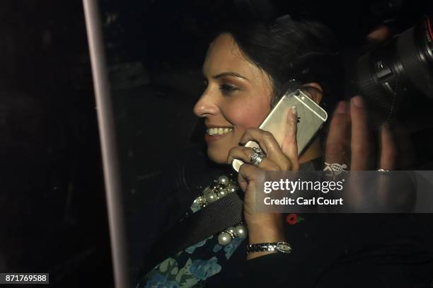 British Secretary of State for International Development Priti Patel talks on a mobile phone in a car as she arrives to Downing Street on November 8,...