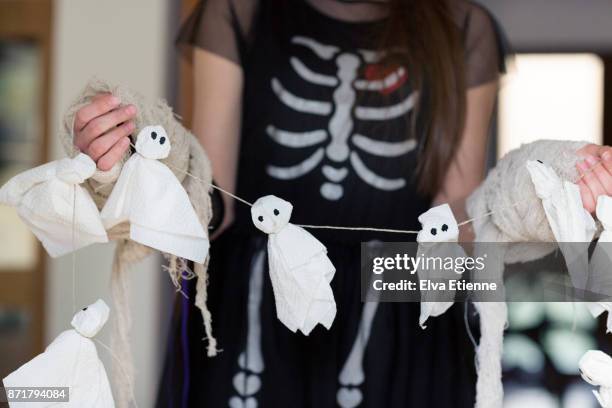 teenager holding tissue paper halloween ghost decoration - halloween craft stock pictures, royalty-free photos & images