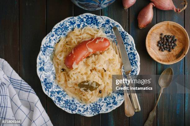 sauerkraut and sausage on plate - sauerkraut stock pictures, royalty-free photos & images