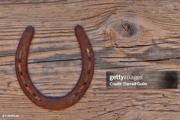 horseshoe on wooden wall - horseshoe stock pictures, royalty-free photos & images