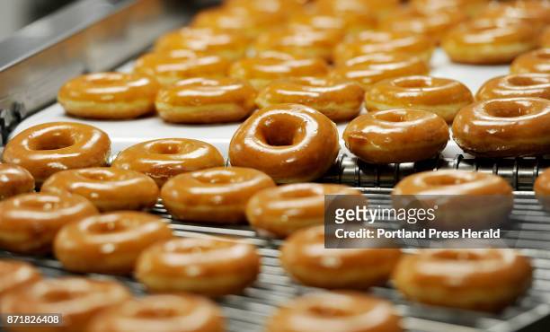Donuts on the 270 machine at Krispy Kreme in Saco Tuesday, October 3, 2017. The 270 machine makes 270 dozen donuts per hour.