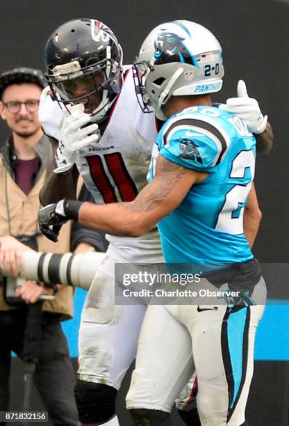 Carolina Panthers free safety Kurt Coleman talks with Atlanta Falcons wide receiver Julio Jones after Jones missed a wide open pass in the end zone...