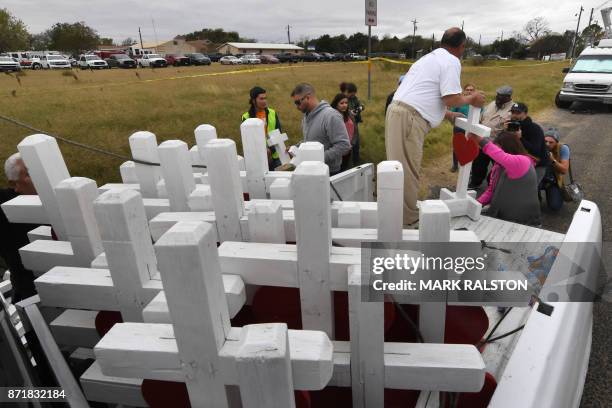 Greg Zanis who drove from Chicago, unloads crosses for each victim outside the First Baptist Church which was the scene of the mass shooting that...