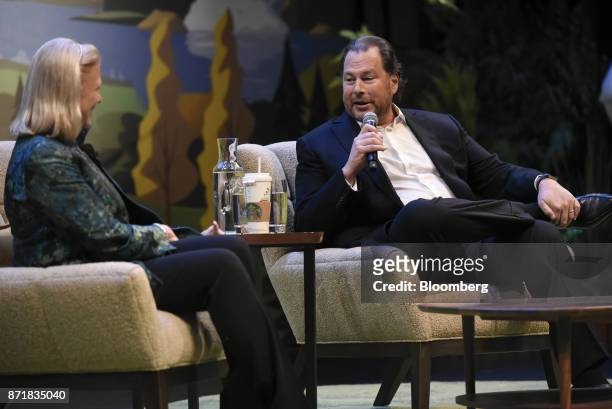 Marc Benioff, chairman and chief executive officer of Salesforce.com Inc., right, speaks as Ginni Rometty, chief executive officer of International...