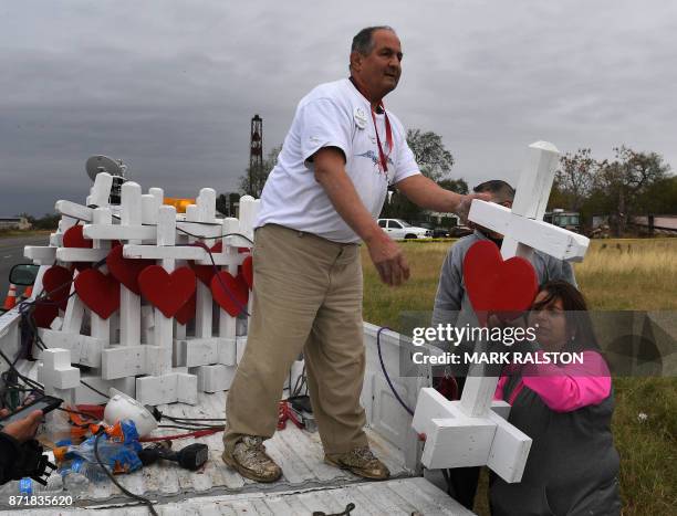 Carpenter Greg Zanis who drove from Chicago unloads his crosses outside the First Baptist Church which was the scene of the mass shooting that killed...