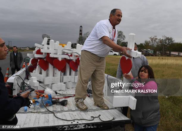 Carpenter Greg Zanis who drove from Chicago unloads his crosses outside the First Baptist Church which was the scene of the mass shooting that killed...