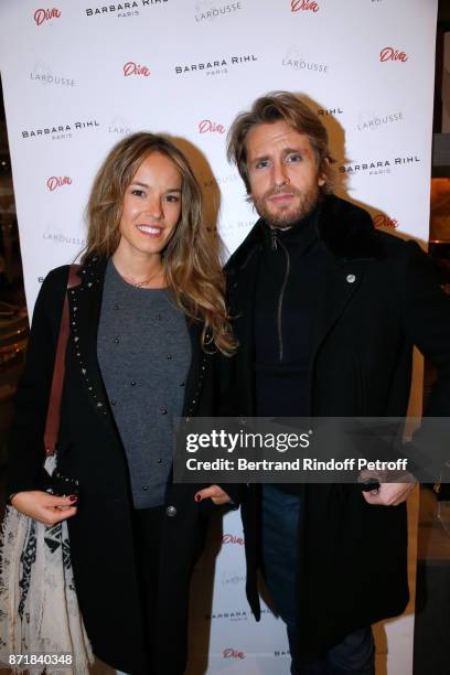 Elodie Fontan and Philippe Lacheau attend Reem Kherici signs her book "Diva" at the Barbara Rihl Boutique on November 8, 2017 in Paris, France.