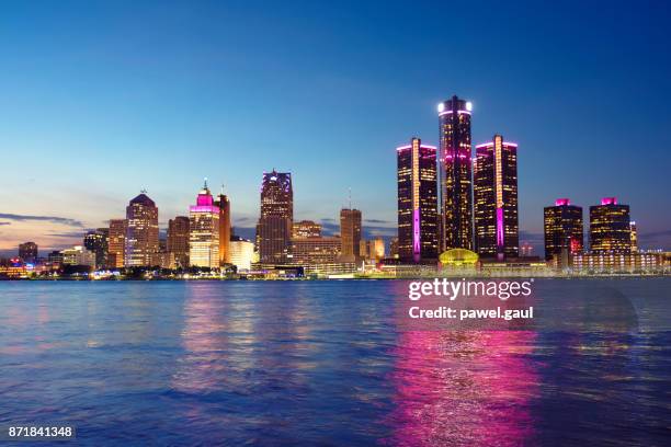 detroit skyline reflected in water during sunset - detroit michigan night stock pictures, royalty-free photos & images