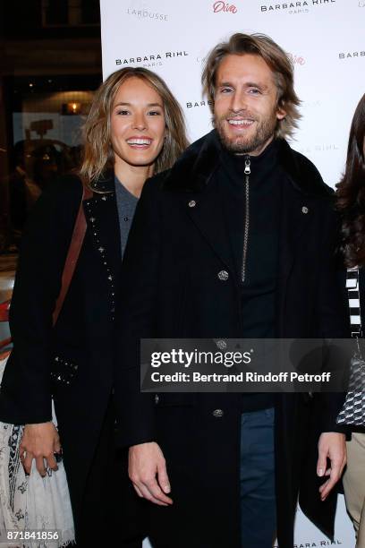 Elodie Fontan and Philippe Lacheau attend Reem Kherici signs her book "Diva" at the Barbara Rihl Boutique on November 8, 2017 in Paris, France.