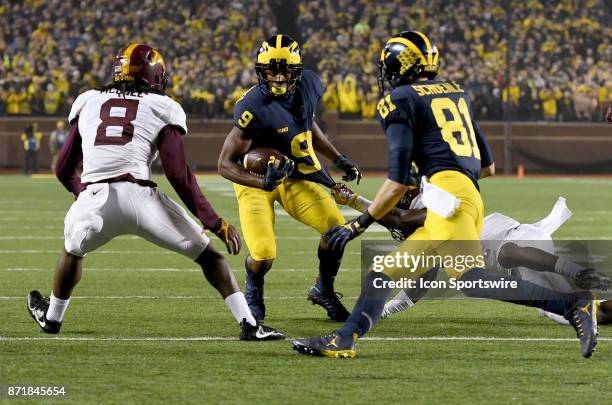 Michigan wide receiver Donovan Peoples-Jones tries to avoid being pulled down by his jersey after catching a third quarter pass from quarterback...