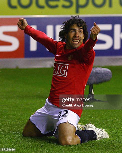 Carlos Tevez of Manchester United celebrates after scoring the equalizing goal during the Barclays Premier League match between Wigan Athletic and...