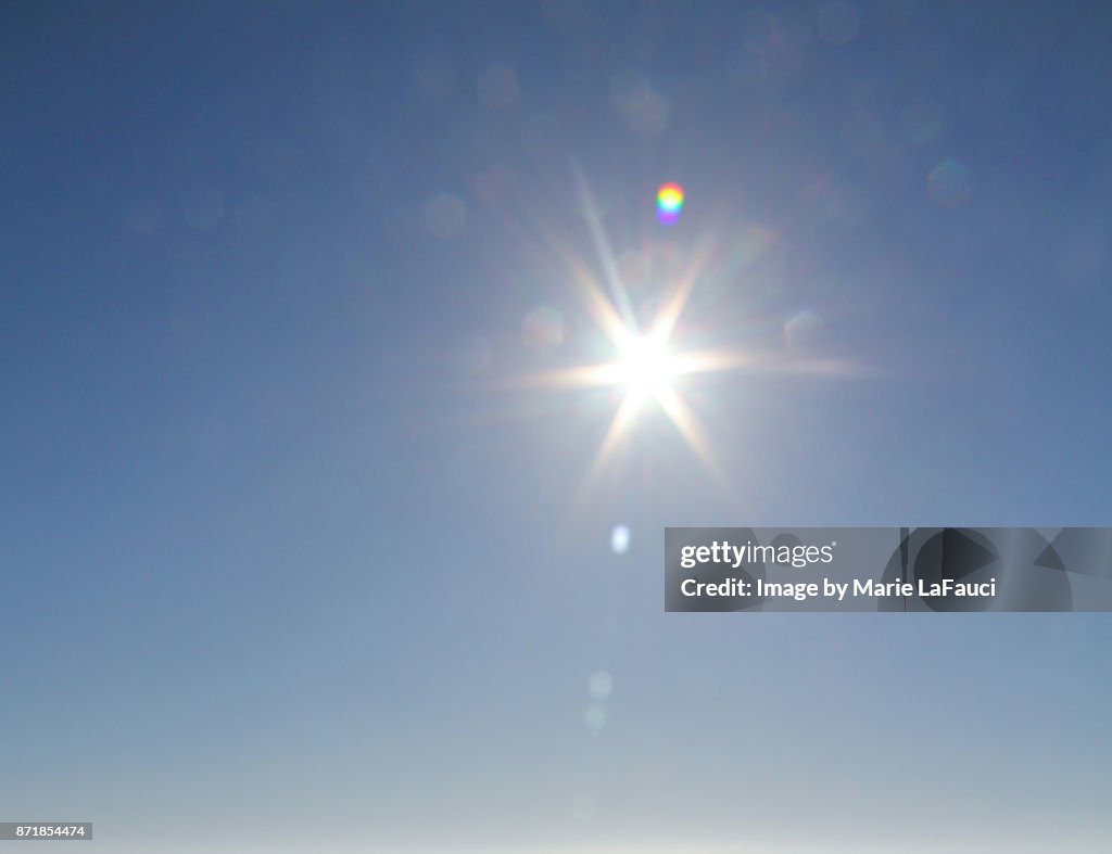 Bright sunshine glare against blue sky