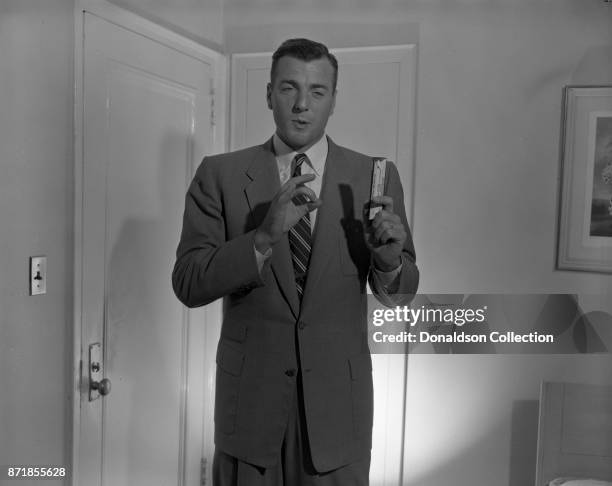 Decathlete Bob Mathias poses for a studio portrait holding an Almond Joy candy bar at NBC on April 11, 1956 in New York.