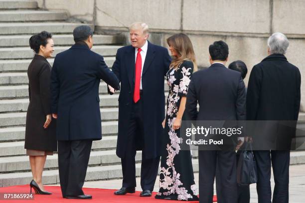 Chinese President Xi Jinping and first lady Peng Liyuan greets U.S. President Donald Trump and first lady Melania Trump at a welcoming ceremony...