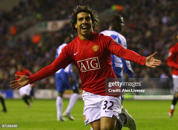 Carlos Tevez of Manchester United celebrates after scoring the equalizing goal during the Barclays Premier League match between Wigan Athletic and...