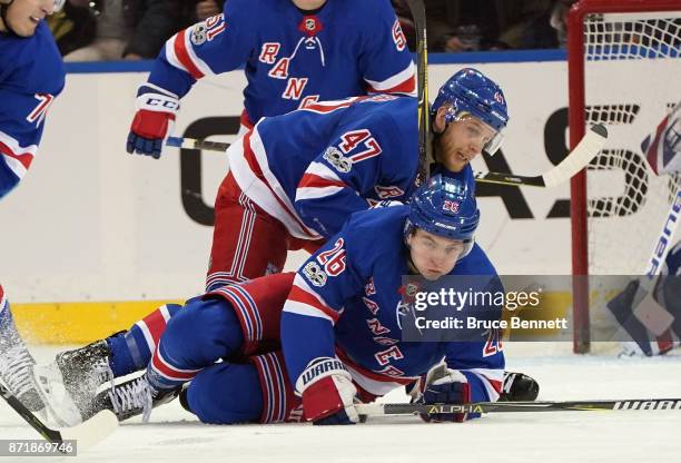 Steven Kampfer of the New York Rangers runs into Jimmy Vesey during the second period against the Boston Bruins at Madison Square Garden on November...