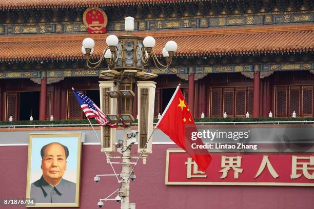 China and US flag is displayed in front of the portrait of China's late communist leader Mao Zedong outside the Forbidden City on November 9, 2017 in...