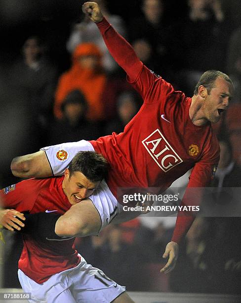 Manchester United's English midfielder Michael Carrick celebrates after scoring the second goal with Manchester United's English forward Wayne Rooney...