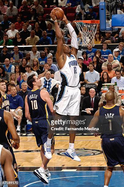 Dwight Howard of the Orlando Magic goes for the dunk against Jeff Foster of the Indiana Pacers during the game on January 27, 2009 at Amway Arena in...