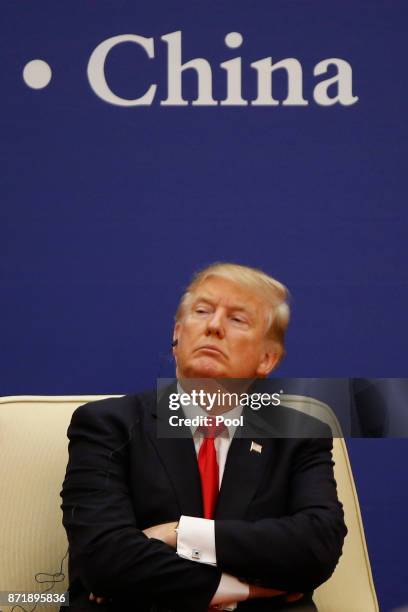 President Donald Trump meets business leaders with China's President Xi Jinping at the Great Hall of the People on November 9, 2017 in Beijing,...