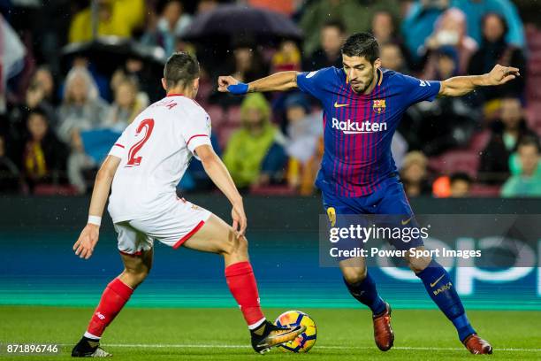 Luis Alberto Suarez Diaz of FC Barcelona and Sebastien Corchia of Sevilla FC during the La Liga 2017-18 match between FC Barcelona and Sevilla FC at...