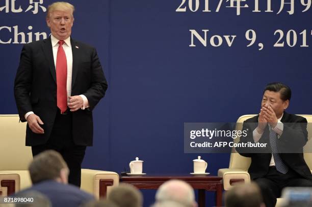 President Donald Trump speaks during a business meeting with Chinese President Xi Jinping at the Great Hall of the People in Beijing on November 9,...
