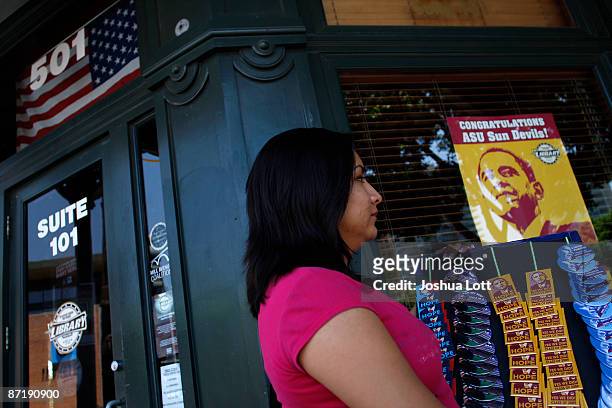 Vendor sells buttons of US President Barack Obama before the start of the Arizona State University graduation outside of Sun Devil Stadium May 13 in...