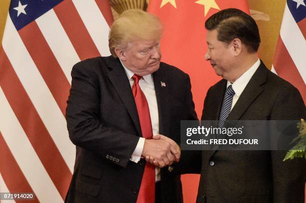 President Donald Trump shakes hand with China's President Xi Jinping at the end of a press conference at the Great Hall of the People in Beijing on...