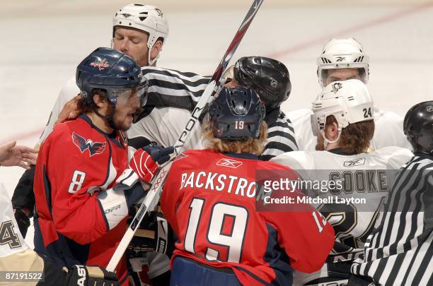Matt Cooke of the Pittsburgh Penguins and Alex Ovechkin of the Washington Capitals are separated by an official during Game Seven of the Eastern...