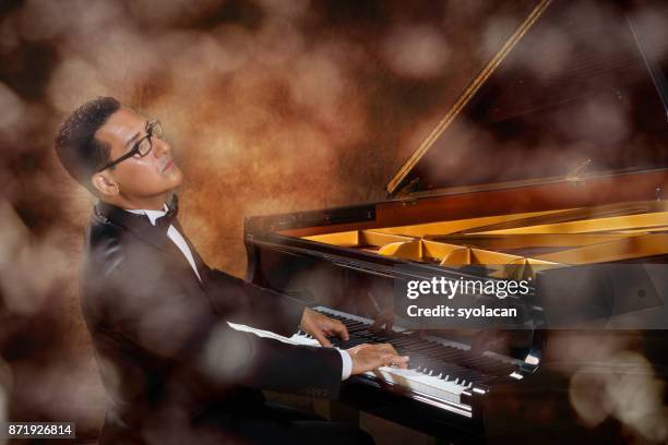 pianist during performance - piano concert stock pictures, royalty-free photos & images