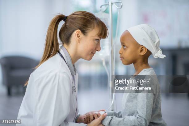doctor and child - bald girl stock pictures, royalty-free photos & images