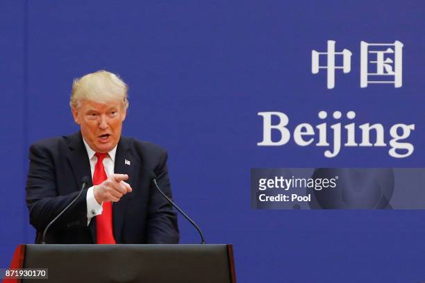 President Donald Trump and China's President Xi Jinping speak to business leaders at the Great Hall of the People on November 9, 2017 in Beijing,...
