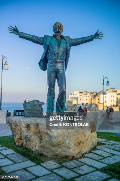 The statue of Domenico Modugno, born in Polignano a Mare, in a village square in Puglia, southern Italy.