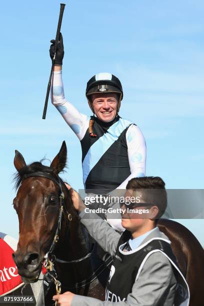 Jockey Stephen Baster celebrates as he returns to scale after winning race 8, the Kennedy Oaks, on Pinot on 2017 Oaks Day at Flemington Racecourse on...