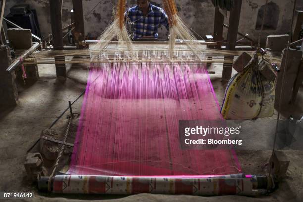 Weaver uses a handloom to make a silk saree at a workshop in Varanasi, Uttar Pradesh, India, on Friday, Oct. 27, 2017. In Varanasi, where the...