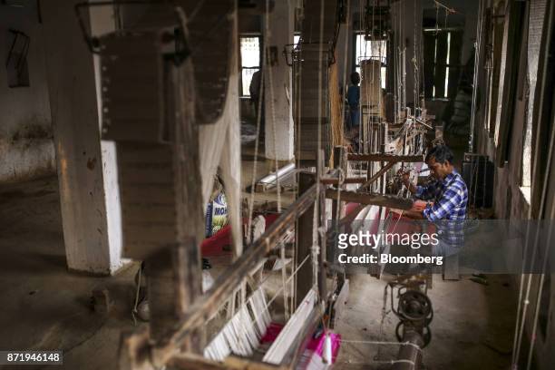 Weaver uses a handloom to make a silk saree at a workshop in Varanasi, Uttar Pradesh, India, on Friday, Oct. 27, 2017. In Varanasi, where the...