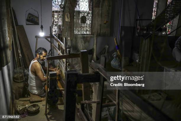 Weaver uses a handloom to make a silk saree in a workshop in Varanasi, Uttar Pradesh, India, on Friday, Oct. 27, 2017. In Varanasi, where the...