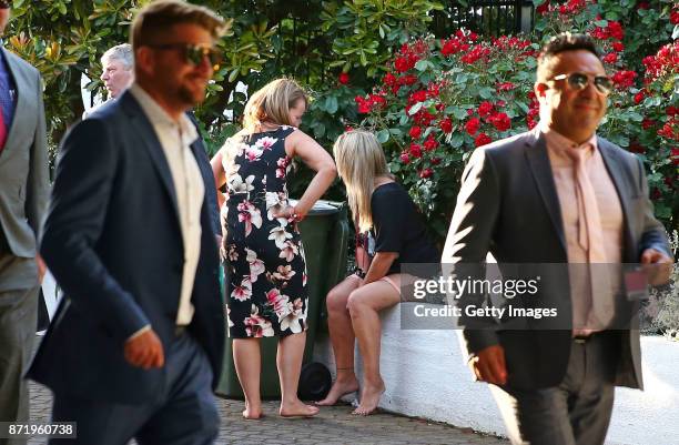 Racegoers take a rest as they make their way from the course following 2017 Oaks Day at Flemington Racecourse on November 9, 2017 in Melbourne,...