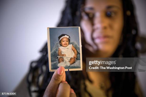 Brandy Johnson Billie holds a photograph of her daughter, Ashanti, a 19-year-old college student, who disappeared going to work. Ashanti was later...