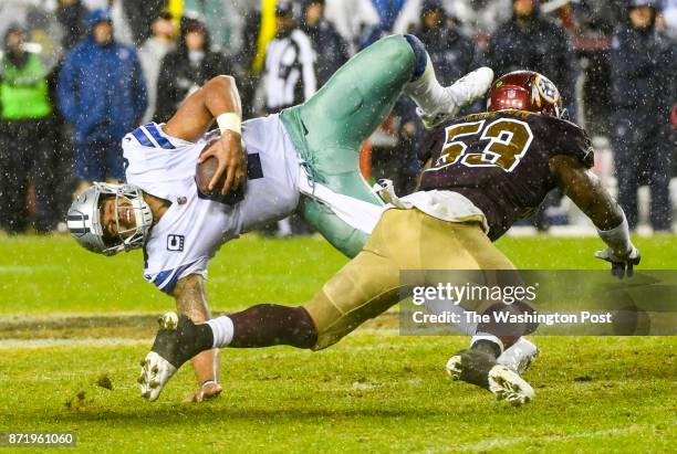 Dallas Cowboys quarterback Dak Prescott is upended by Washington Redskins inside linebacker Zach Brown as he rushes on a quarterback keeper during...