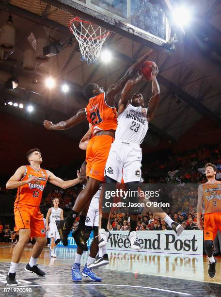 Nnanna Egwu of the Taipans denies Casey Prather a basket during the round six NBL match between the Cairns Taipans and Melbourne United at Cairns...