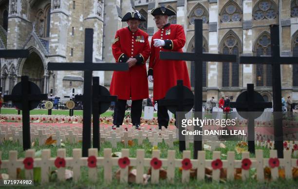 Chelsea pensioners look at Crosses of Remembrance, as they pay their respects at Field of Remembrance at Westminster Abbey in central London on...