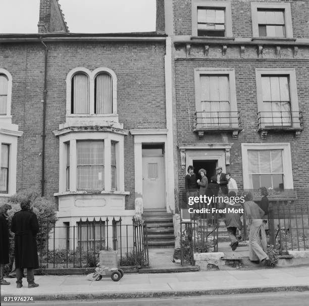 Group of squatters outside an occupied house, UK, 16th May 1977.