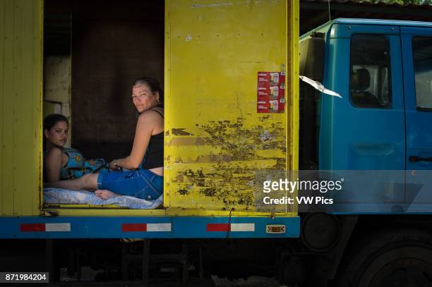 Cuban migrants inside a truck, they use it as a temporary shelter.
